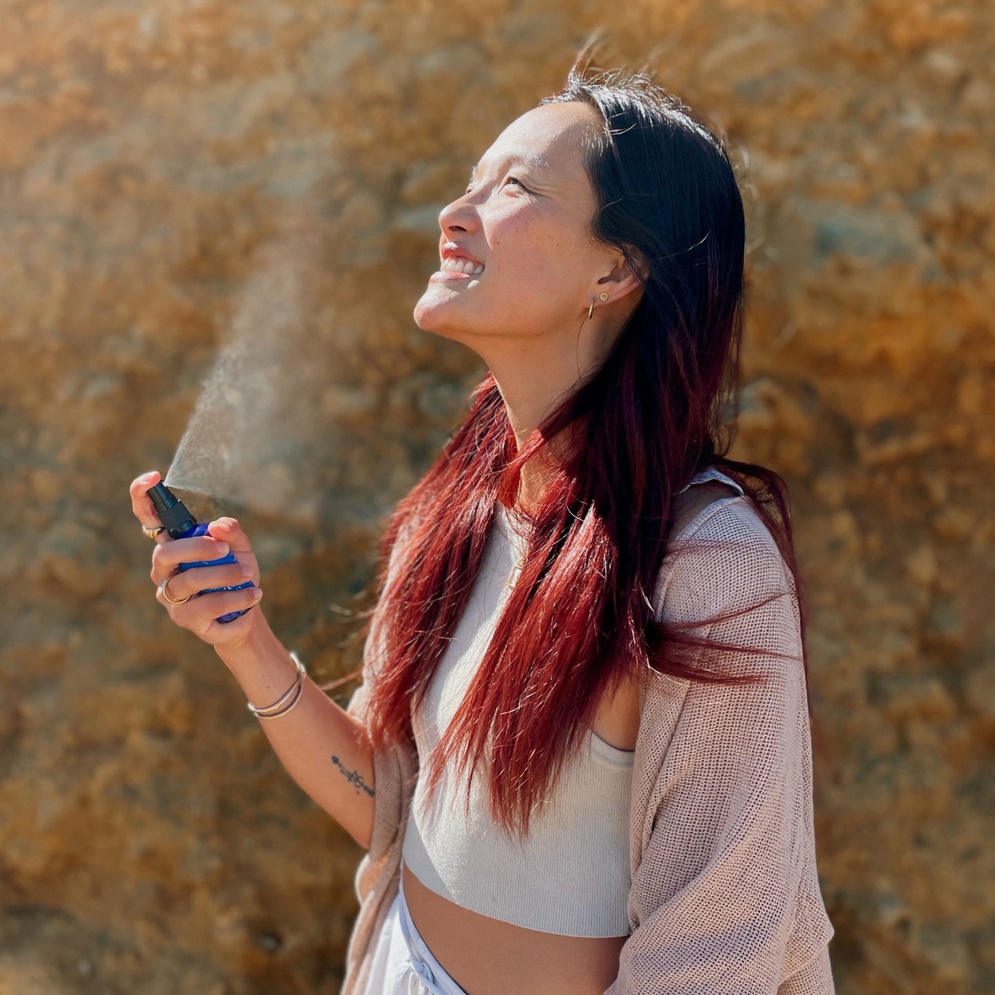 girl spraying clarity mist with blue lotus blue lily essential oil for relaxation