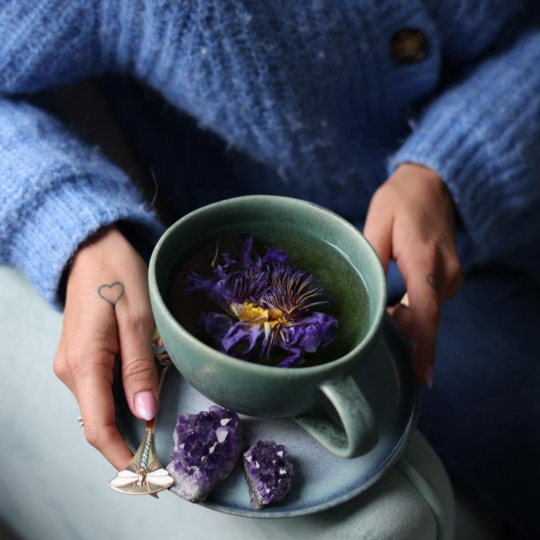 drinking blue lotus tea for meditation